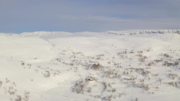 Cabin At Snowy Mountain Of Hardangervidda Near Haugastol In Norway At Winter Season. - aerial