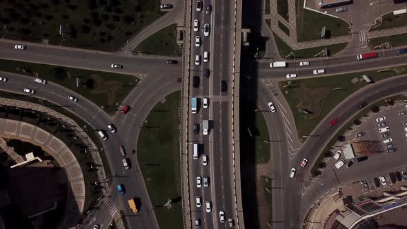 Drone's Eye View -  Overhead Aerial View Of Traffic Driving Over A Modern Bridge