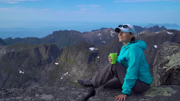 A Girl Is Drinking Tea in the Mountains
