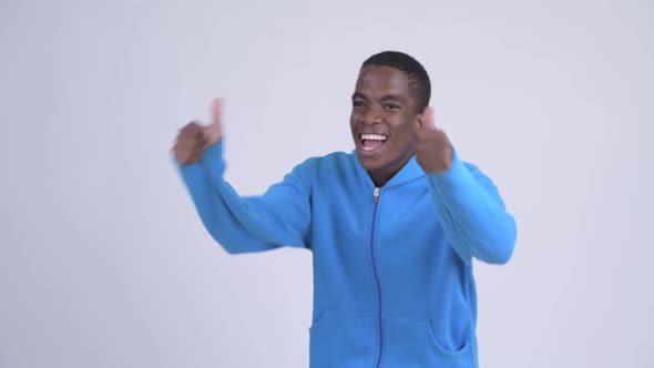 Young Happy African Man Looking Excited While Giving Thumbs Up