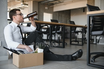 sman drinking alcohol in front of corporation after got fired. Business concept.