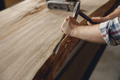 Close up of craftsman working with chisel while cutting wooden plank in carpentry workshop - PhotoDune Item for Sale