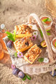 Homemade plum yeast cake on basket in summer on beach. - PhotoDune Item for Sale