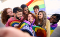 Fun selfie LGBT group young friends celebrating gay pride day together holding rainbow flag.  - PhotoDune Item for Sale