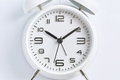 Close-up of a white alarm clock on a white background, ten o'clock. - PhotoDune Item for Sale