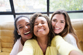 Selfie photo three cheerful young girls posing smiling indoors. Group of attractive women together. - PhotoDune Item for Sale