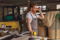 Smiling carpenter in eyeglasses standing on the background on carpentry workshop - PhotoDune Item for Sale