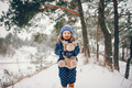 Little girl in a blue hat playing in a winter forest - PhotoDune Item for Sale