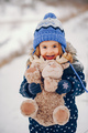 Little girl in a blue hat playing in a winter forest - PhotoDune Item for Sale
