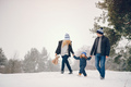 Little girl with parents playing in a winter park - PhotoDune Item for Sale