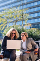 businessman and woman working outdoors with laptop - PhotoDune Item for Sale