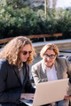 businessman and woman working outdoors with laptop - PhotoDune Item for Sale