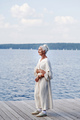 Senior woman in dress standing on pier - PhotoDune Item for Sale
