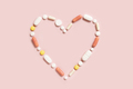 Heart shape made of colorful drug pills and capsules on light pink, top view - PhotoDune Item for Sale
