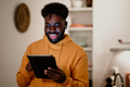 Happy african american millennial man standing in his cozy apartment - PhotoDune Item for Sale