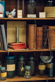 Vintage books and jars on a shelf in an apothecary. - PhotoDune Item for Sale