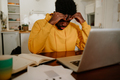 An african american overworked entrepreneur is having a headache while working from home. - PhotoDune Item for Sale