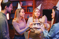 Friends standing together, holding a plate with a cake and celebrating birthday - PhotoDune Item for Sale