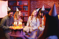 Blurred woman holding a plate with birthday cake in front of people on a party - PhotoDune Item for Sale