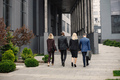 Backside photo of a business people walking toward modern office - PhotoDune Item for Sale