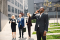 Black businessman standing and talk on the phone in front of modern office - PhotoDune Item for Sale