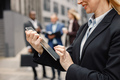 Cropped photo of hands of businesswoman standing and using a tablet - PhotoDune Item for Sale