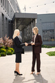 Business people standing and shake hands in front of modern office - PhotoDune Item for Sale