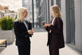Business women standing and talk to each other in front of modern office - PhotoDune Item for Sale