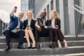 Business people sitting on a stairs and make a selfie - PhotoDune Item for Sale