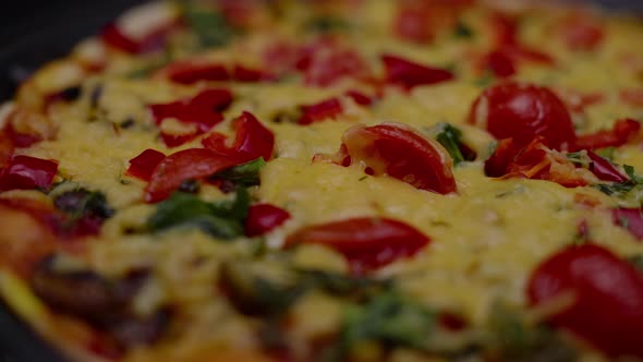 Closeup Homemade Pizza with Cheese and Tomatoes in a Turning Motion