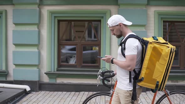 Delivery Man Courier Arrives at Residential Address To Deliver Food Order