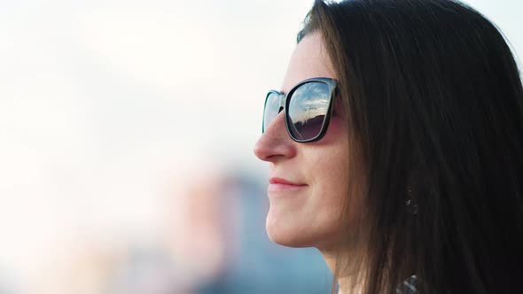 Side View Close Up Face of Happy Woman in Sunglasses Enjoying Sunset Standing Outdoor