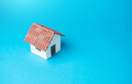 Miniature house on a blue background.  - PhotoDune Item for Sale
