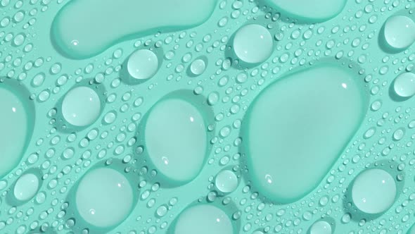 Macro Shot of Cosmetic Moisturizing Drops of Liquid on a Greenblue Pastel Background