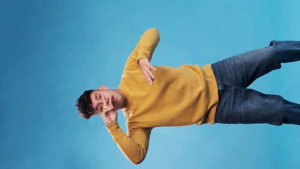 Happy and cheerful man enjoying while dancing against an isolated background.