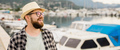 Banner millennial man wearing hat and glasses near marina with yachts. Portrait of laughing man with - PhotoDune Item for Sale