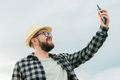 Traveller millennial man taking selfie outdoor on sky background - travel and summer concept - PhotoDune Item for Sale