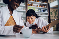 Multiracial pharmacists make medicament in a vintage pharmacy. - PhotoDune Item for Sale