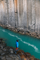 A man standing next to the turquoise water in the canyon and admiring nature. - PhotoDune Item for Sale