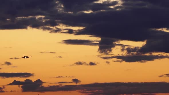 Airplane is Landing at Sunset