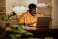 A focused african american adult student is working on a school project - PhotoDune Item for Sale