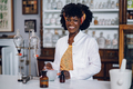 Interracial pharmacist is standing in a vintage apothecary - PhotoDune Item for Sale