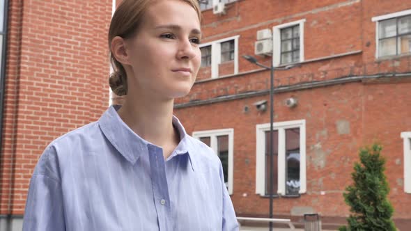 Young Casual Woman Walking on Street in Slow Motion