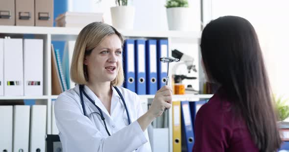 Neurologist Examines Nervous System of Young Patient with Hammer