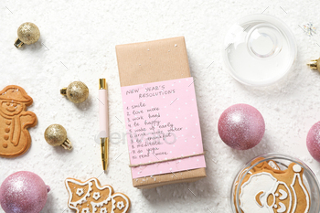 Cookies and paper with list on box on white background, top view