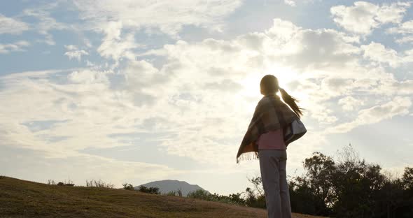 Woman look at the sky with sun flare light