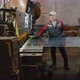 A Professional Engineer is Laying a Sheet of Metal on a Cutting Machine - VideoHive Item for Sale