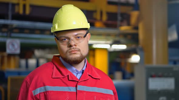 Factory Worker in Uniform Posing on Industrial Plant