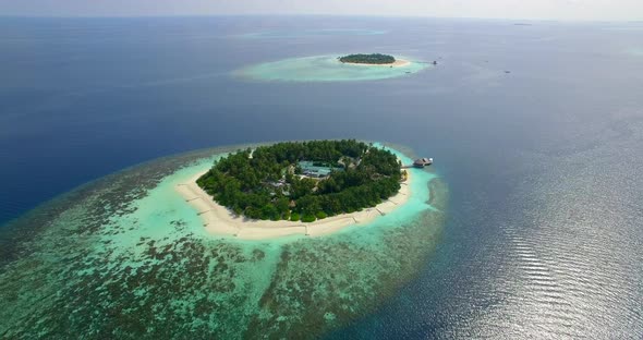 Aerial drone view of scenic tropical islands in the Maldives.