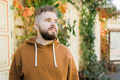 Outdoor portrait of young handsome smiling curly hair style man with beard in spring season - copy - PhotoDune Item for Sale